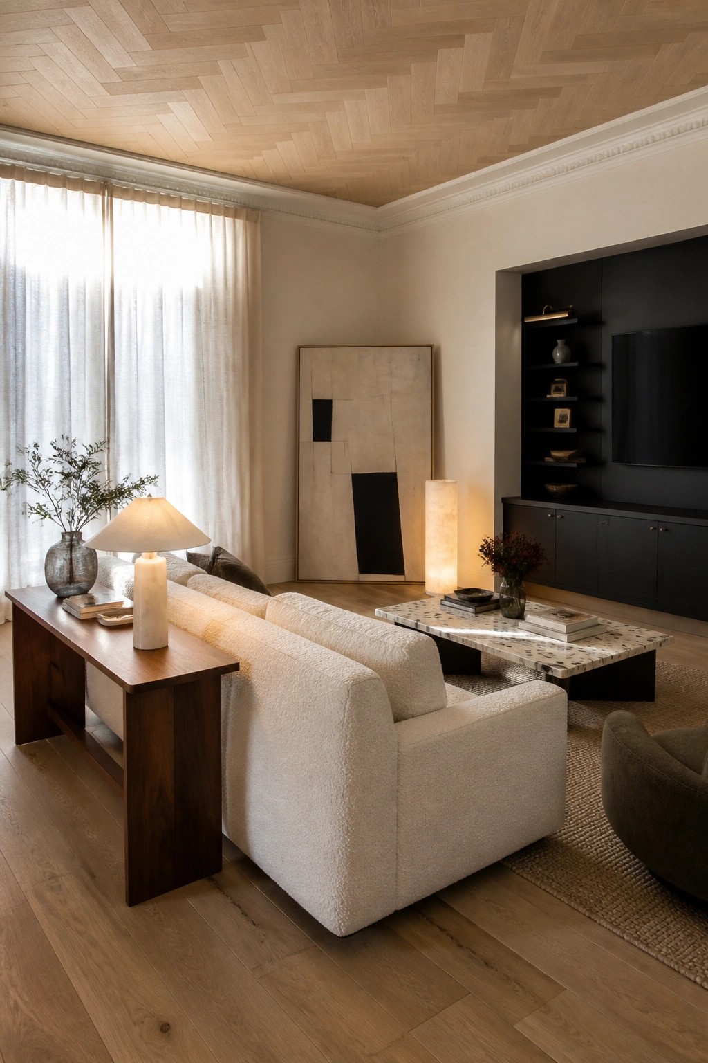 A living room with a light wood herringbone ceiling, white bouclé sofa, marble coffee table, wooden console, and dark built-in shelving unit.