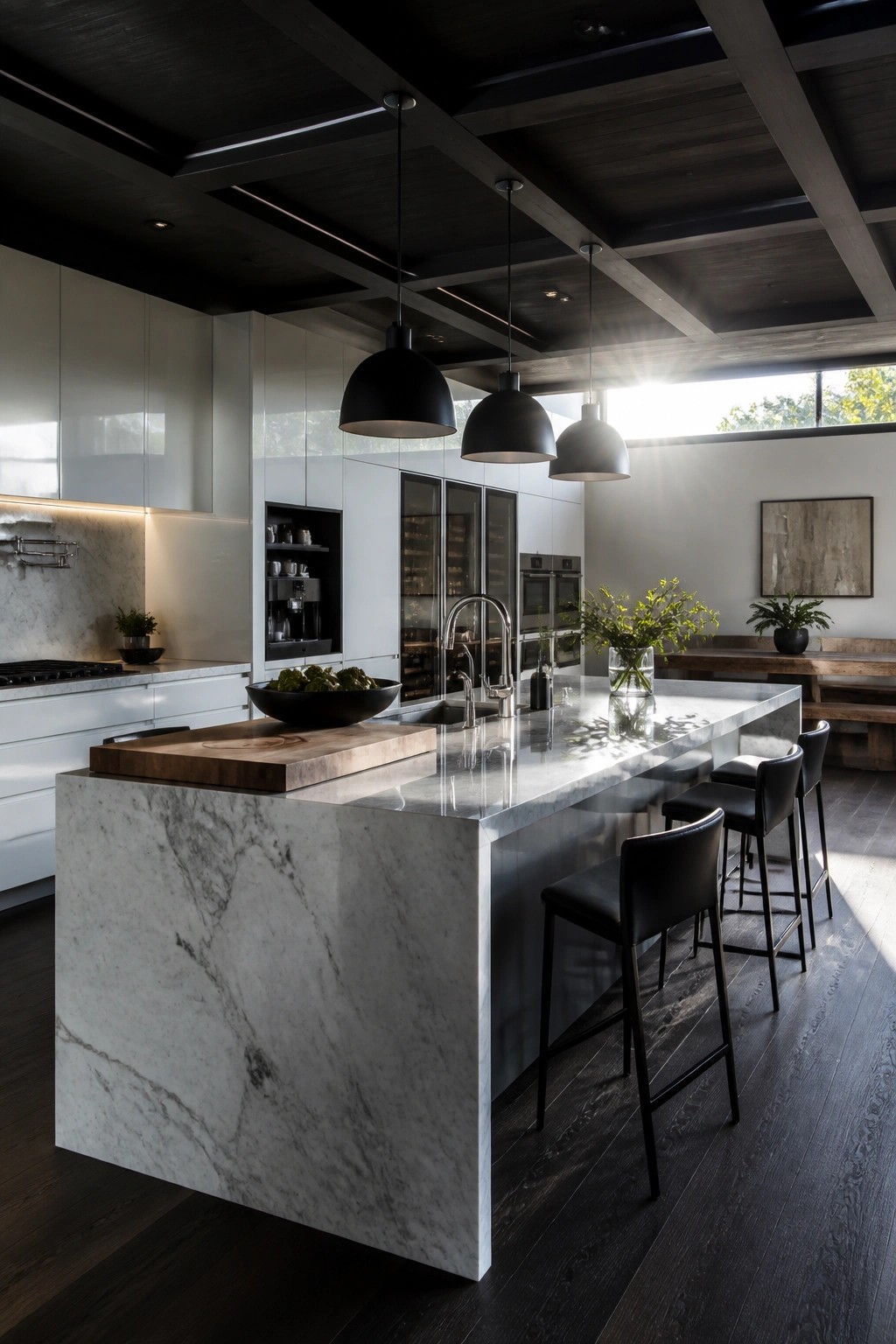 A modern kitchen featuring a large marble island, black leather bar stools, white cabinets, and a prominent dark wood coffered ceiling with three black pendant lights.