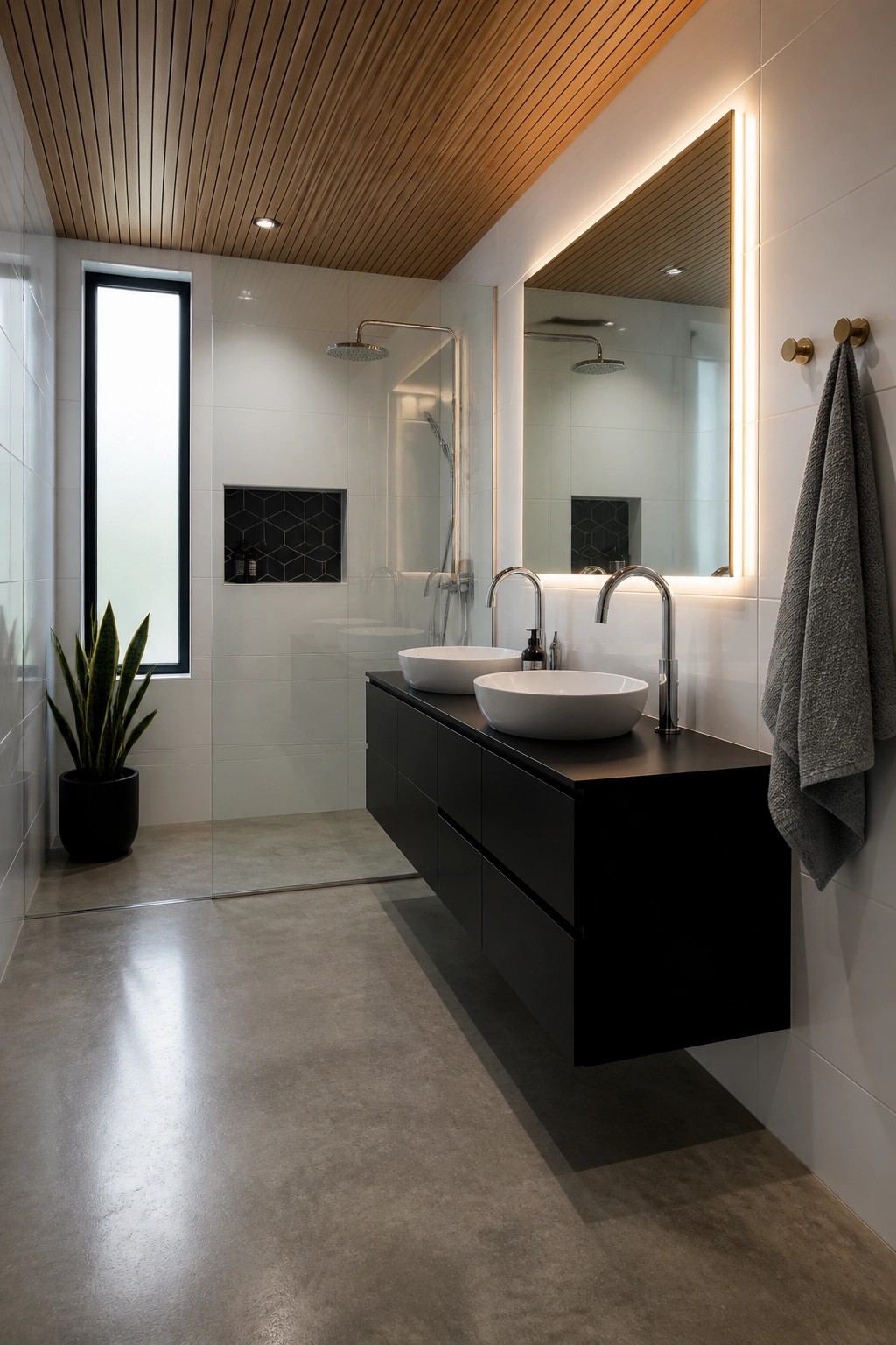 A modern bathroom interior featuring a slatted wood ceiling, white tiled walls, a floating black vanity with two white vessel sinks, and a glass shower enclosure.