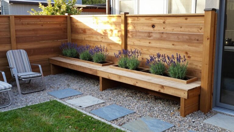 21 Easy Wood Fence Ideas Perfect for Beginner DIY Projects Backyard view showing two long wooden raised planter boxes with lavender and other plants, a gravel path with stone pavers, a wooden bench, and two lounge chairs set against a tall horizontal wood fence.
